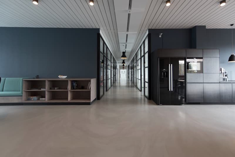 Linear metal false ceiling running through a finished office corridor