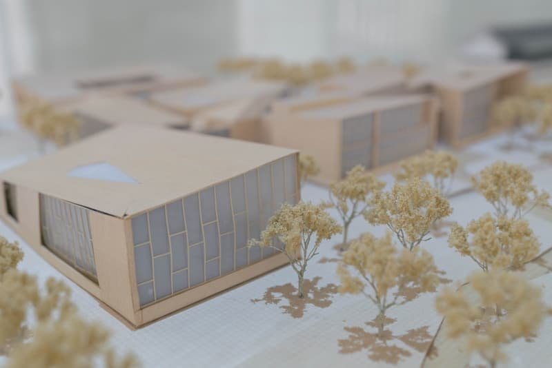 Architectural scale models of a building block on a presentation table